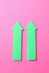 Green arrows on pink background, top view