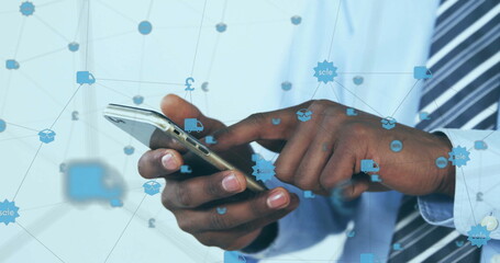 Image of globe of connections with icons over afrcian american businessman using smartphone