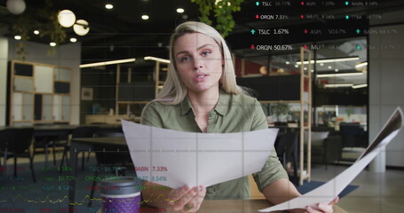 Image of financial data processing over caucasian businesswoman in office