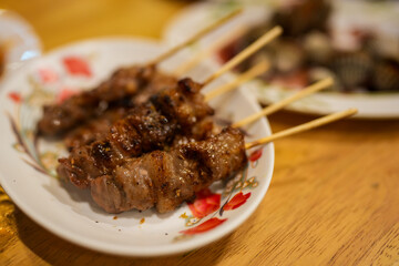 A sizzling plate of grilled beef skewers, grilled beef skewers, Thai street food