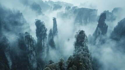 Fototapeta premium Majestic Fog-Covered Mountains with Towering Pinnacles Surrounded by Lush Greenery in a Serene Landscape