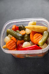 Marinated vegetables mix salad cucumber, corn, pepper, carrot, cauliflower, onion fresh tasty food dish gourmet food background on the table rustic food top view copy space vegetarian and vegan food