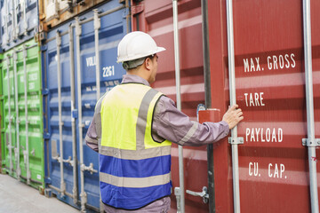 Customs clearance officer or shipyard engineer is inspects against the import - export cargo containers. - obrazy, fototapety, plakaty