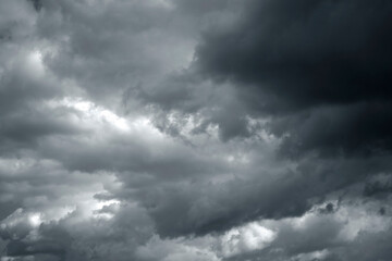 Dramatic stormy sky background. Dark fluffy cloudy sky. Halloween cloudscape background concept.