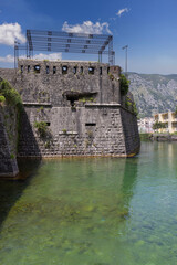 View of river Scurda and stone City Walls with Bembo Bastion, Kotor, Montenegro