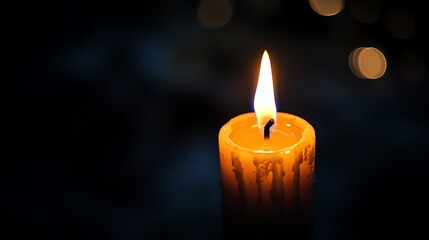 A glowing candle illuminating the dark.