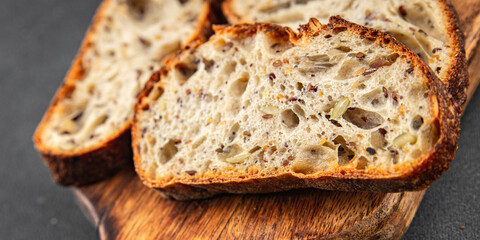 Grain bread sunflower, chia, flax seed, cut oats fresh tasty food dish delicious gourmet food background on the table rustic food top view copy space vegetarian and vegan food