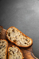 Grain bread sunflower, chia, flax seed, cut oats fresh tasty food dish delicious gourmet food background on the table rustic food top view copy space vegetarian and vegan food