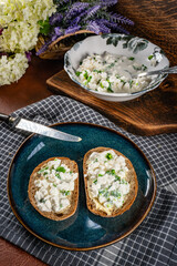 Slices of bread with cottage cheese and green onion.