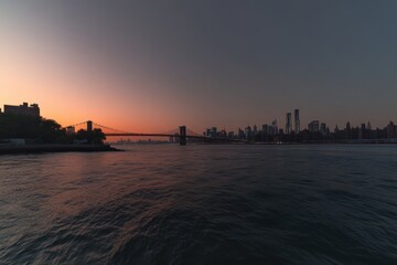 Obraz premium A boat sits in the water before a city skyline at sunset