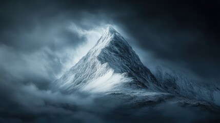 A majestic snow covered mountain rising above swirling clouds