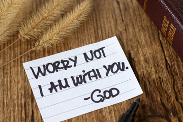 Worry not, I am with you, God, inspirational handwritten quote with holy bible book on wooden...