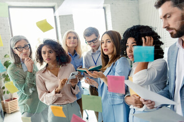 Diverse office team collaborating on ideas together during a business meeting, brainstorming in a friendly and professional corporate environment.