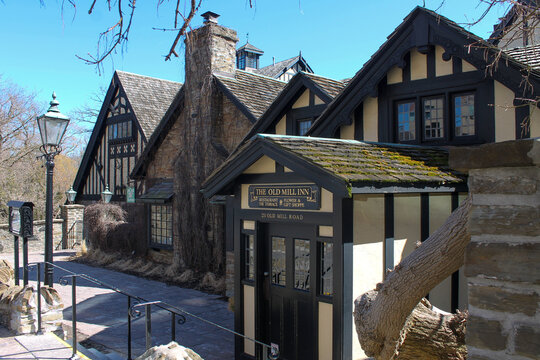 Exterior of The Old Mill Inn, a historic Tudor-style restaurant and gift shop with black timber framing
