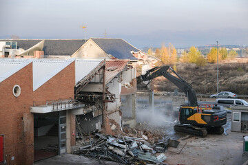A heavy machine works in the demolition of an old factoy to renew the northern part of Madrid....