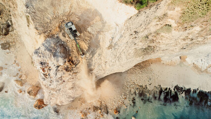 Escalators works on the cliff on ocean coastline. Drone view