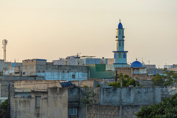 Cityview of poor area of Senegal houses and mosque minaret in Dakar, Senegal
