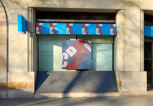 Front view of business retail Storefront with poster inBarcelona, Spain at Sunset Hours