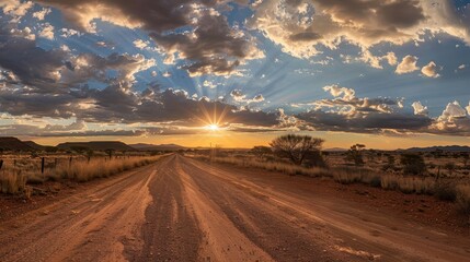 Fototapeta premium Deserted road bathed in warm evening light and fluffy clouds