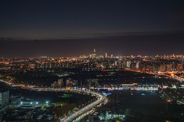 An aerial view of the brightly lit and bustling scene of Beijing's urban night view in China
