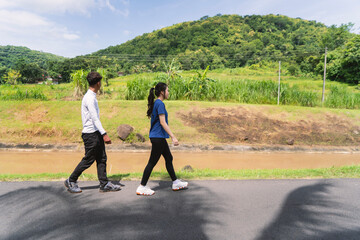 Fototapeta premium active young asian couple walking exercise at rural area