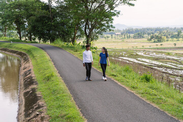 Fototapeta premium active young asian couple walking exercise at rural area