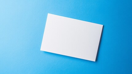 Blank white card on a flat surface, symbolizing simplicity and clarity in design.
