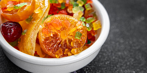 Candied peel and fruit orange, kumquat, tangerine, cherry, mango and others Sugar-coated fruit fresh tasty food dish delicious gourmet food background on the table rustic food top view copy space