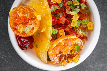 Candied peel and fruit orange, kumquat, tangerine, cherry, mango and others Sugar-coated fruit fresh tasty food dish delicious gourmet food background on the table rustic food top view copy space