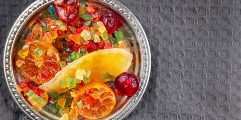 Candied peel and fruit orange, kumquat, tangerine, cherry, mango and others Sugar-coated fruit fresh tasty food dish delicious gourmet food background on the table rustic food top view copy space