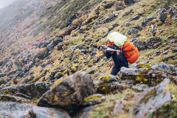 Strong Sherpa man working as porter carrying a huge cargo with traditional method on forehead. High...