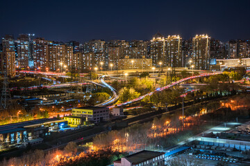Obraz premium The overpasses and high-rise buildings under the night view of Beijing, China are brilliantly illuminated