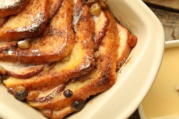 Freshly baked bread pudding in baking dish on table, top view