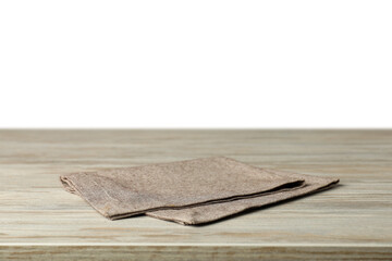Gray napkin on wooden table against white background