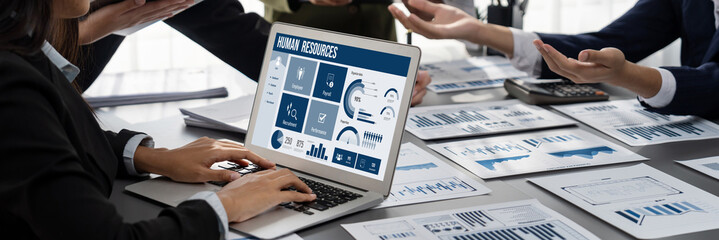 Human resources management software on computer screen helping human resources employee to manage recruitment, payroll, staff searching and KPI evaluation brisk