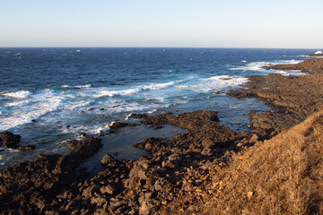 Wild coastal landscape of Linosa, Sicily, with rough sea and rugged cliffs