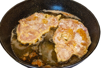 The cooking process in a pan of fried chop in batter.