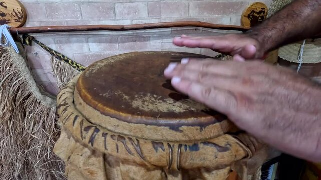 Rio de Janeiro - Rio de Janeiro - Brazil - February 23, 2025: Master playing Atabaque the Capoeira musical instrument in Brazil.