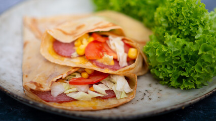 pancakes with salted ham, tomato, herbs and cheese