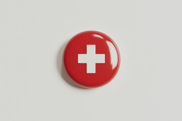 Fototapeta premium Swiss cross button: A shiny, red button prominently displays a white cross, a symbol of safety, aid, and healthcare.