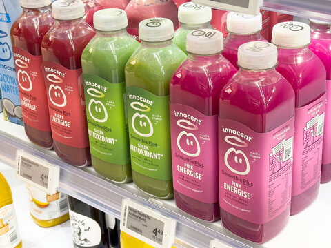 Colorful bottles of innocent smoothie plus drinks on store shelf