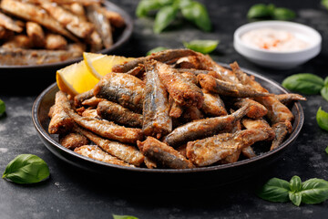Crispy fried sardines with herbs and lemon. Healthy mediterranean food