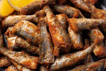 Crispy fried sardines with herbs and lemon. Healthy mediterranean food