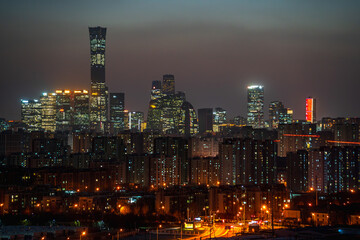 The night view of the city in Beijing, China, when the lights are just coming on. The high-rise buildings are ablaze with lights