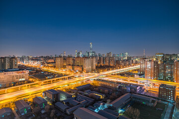 Overpasses and high-rise buildings under the night view of the city in Beijing, China