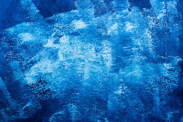 Abstract Blue Paint Texture: A dynamic close-up of a textured surface showcases an abstract composition, capturing a spectrum of blues in a mesmerizing display of color.