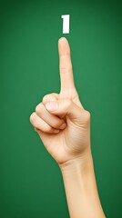 A human hand is pointing upwards toward the number one