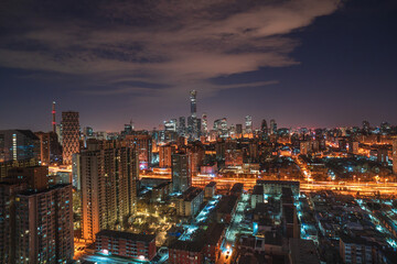 Obraz premium Overlooking the bustling night view of the metropolis in Beijing, China, with the city brightly lit up