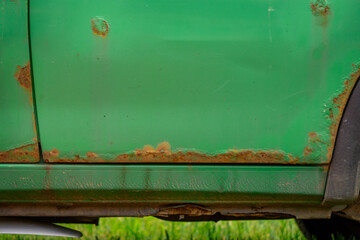 rusty rear door in a damaged car. Rust devastates and destroys car sheet metal.