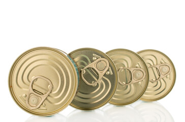 Four metal cans of tuna, close-up, isolated on a white background.